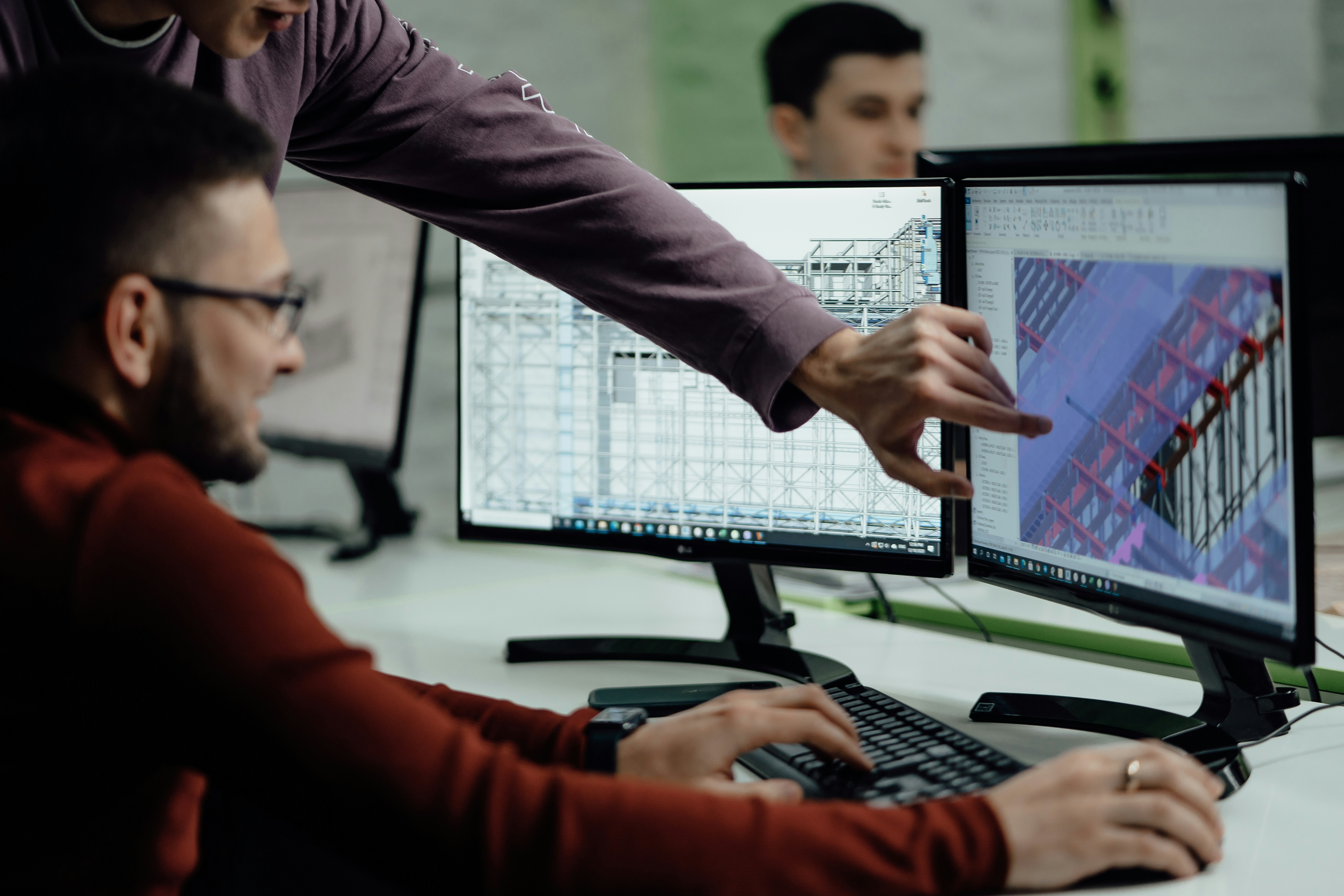 2 team members looking at a graphic on a computer screen 